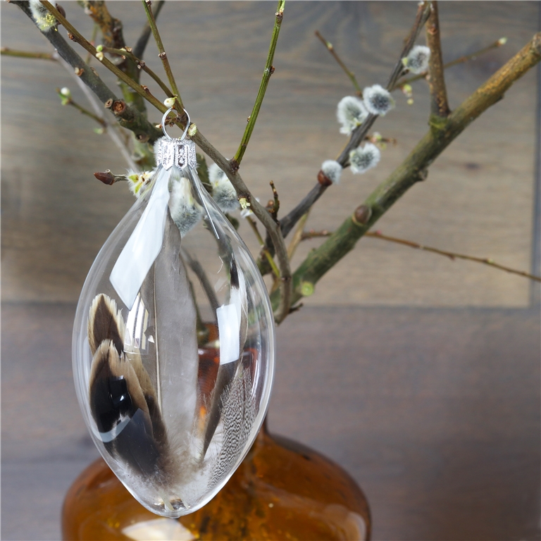 Œuf de Pâques en verre transparent avec plume marron