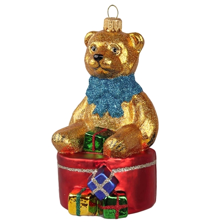 Ours en verre doré sur une boîte cadeau