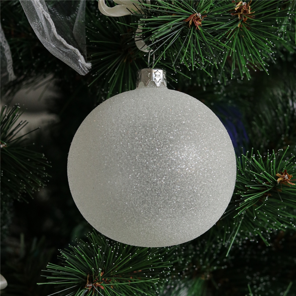 Boule en verre avec des paillettes blanches